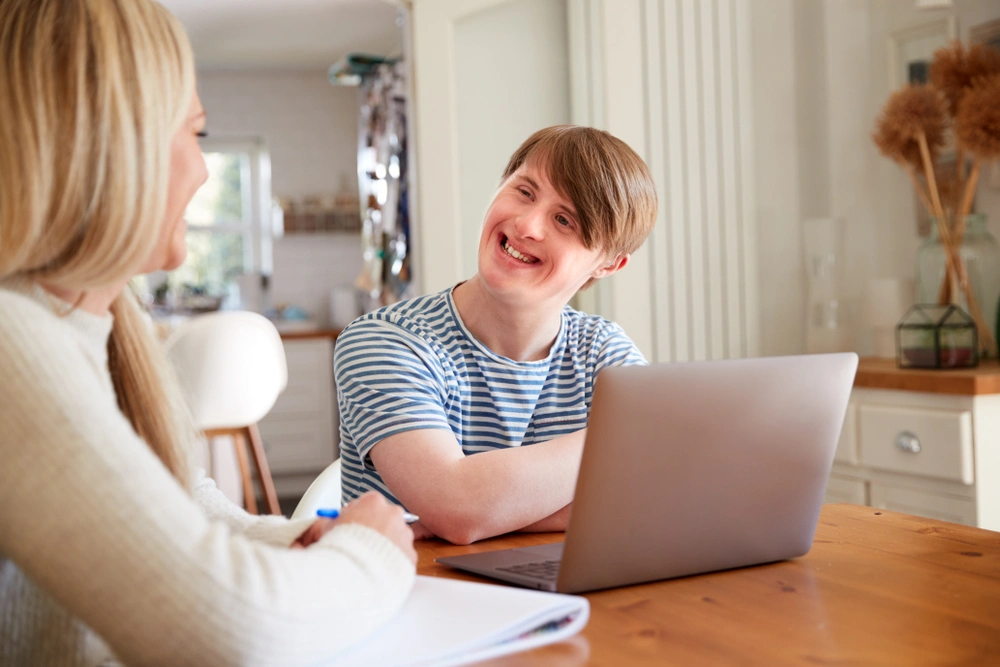 disabled young boy with down syndrome looking at mother and smiling