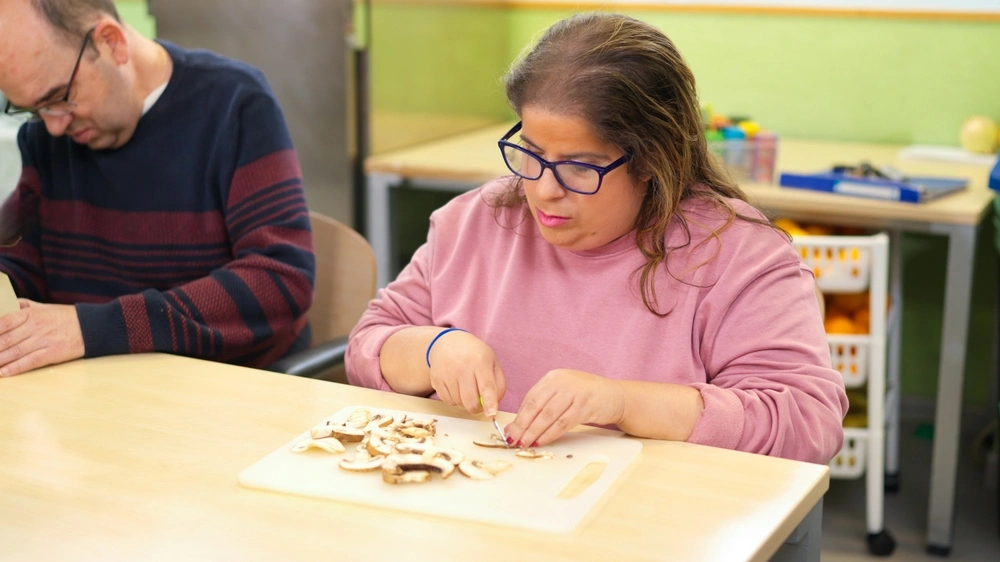 disabled women cutting potatoes